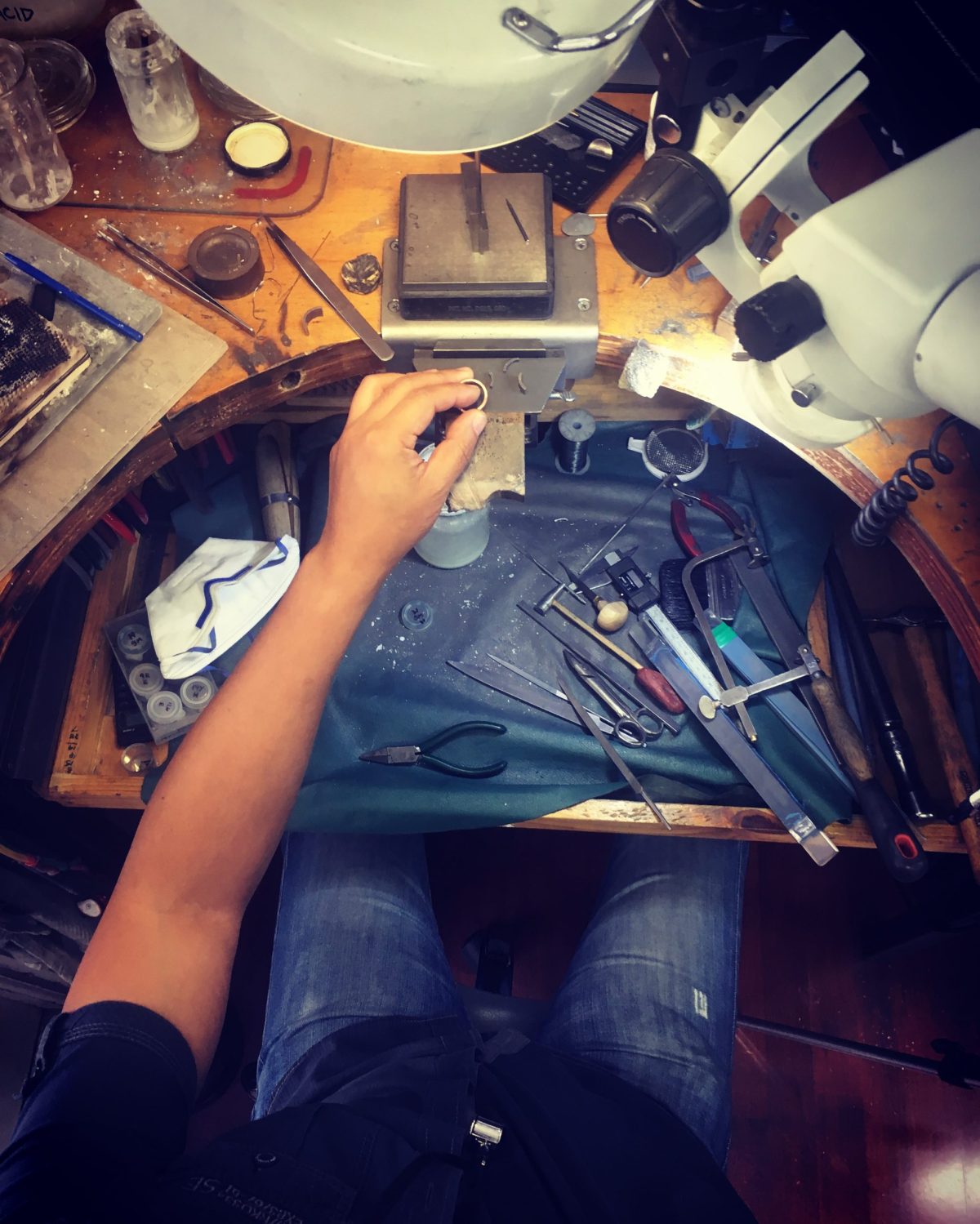 Jewellers sitiing on a jeweller's bench